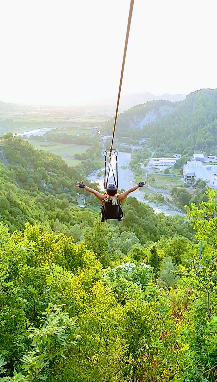 Rider soaring over the Petrelë valley at sunset