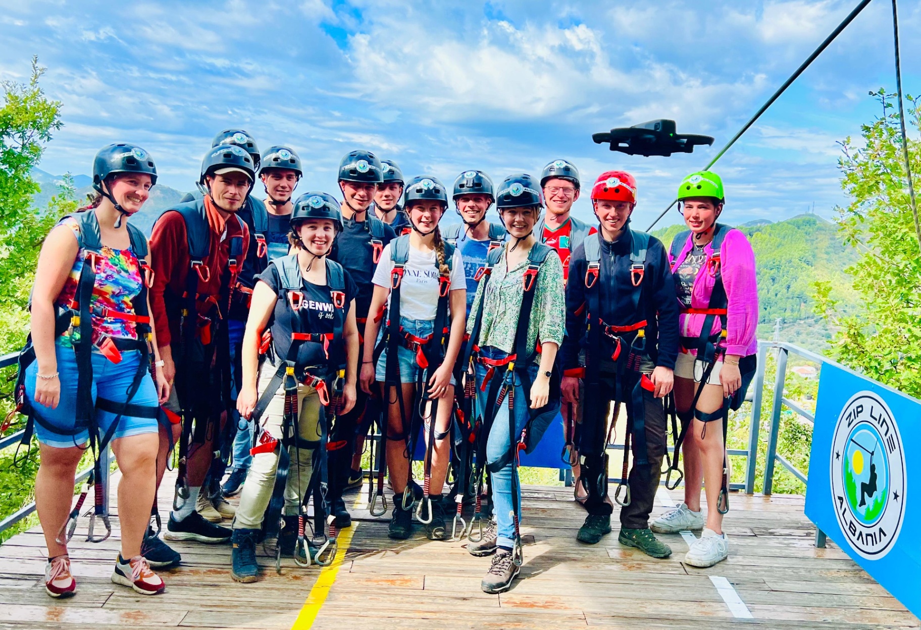 Group photo on the zipline platform with drone